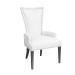 Custom upholstered arm dining chair with flared back, nailhead trim, and wood legs